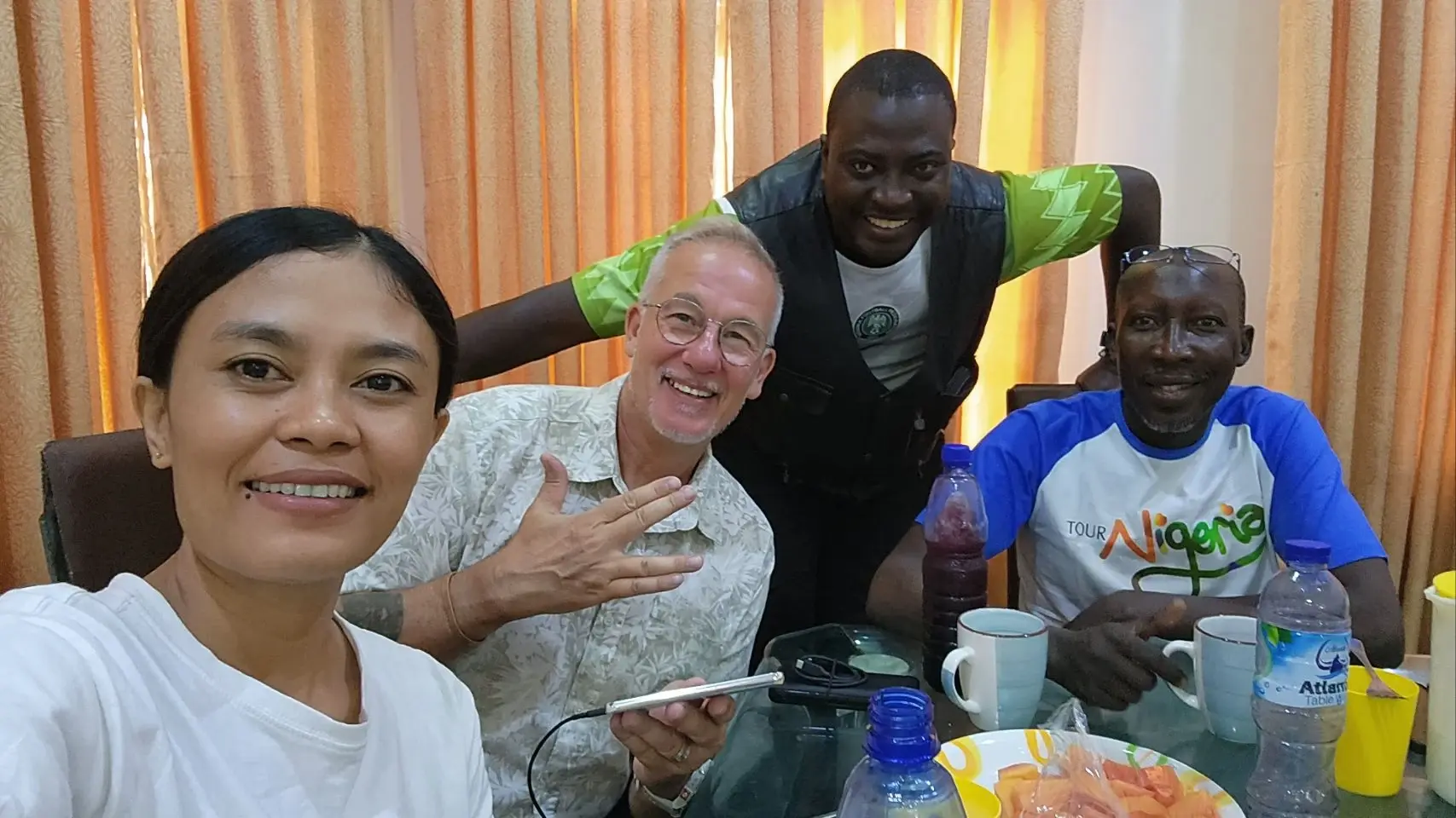 Max, Eddy and two members of the Gombe motorcycle club, close together for a candid photo.